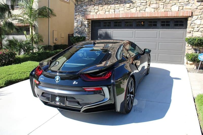 Black BMW EV in driveway after charging at home station