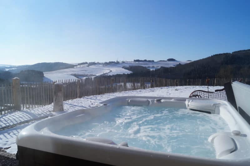 A hot tub with safe outdoor wiring on a snowy day