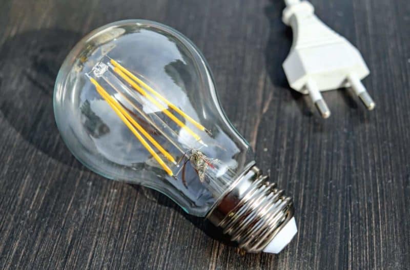 a lightbulb and a plug on a table