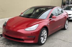 a red Tesla Model 3
