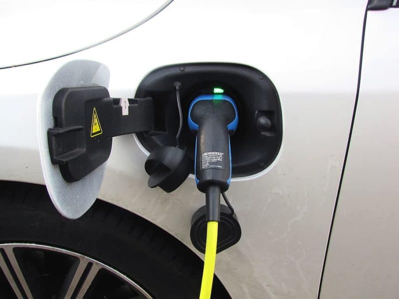 closeup of a charger plugged into an electric vehicle