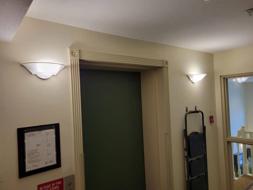 two newly installed LED lights near an elevator