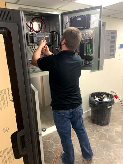 a TCA electrician works on an electrical panel