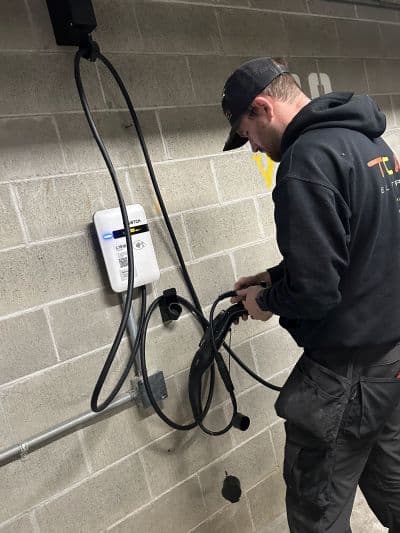 one of TCA Electric's EV charging station contractors installing a SWTCH charger
